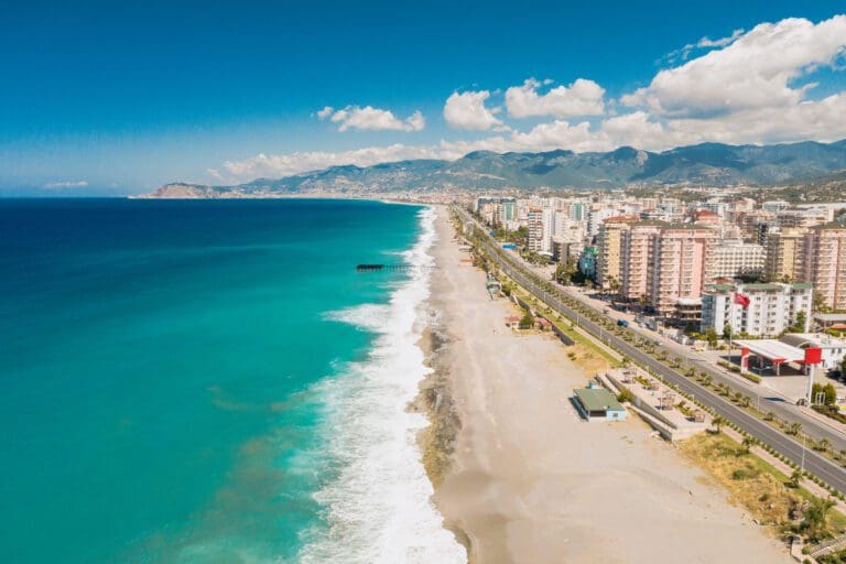 Aerial view of the Antalya city. Mediterranean sea, and the coast of Antalya. Mountains and sky in the background. Turkey