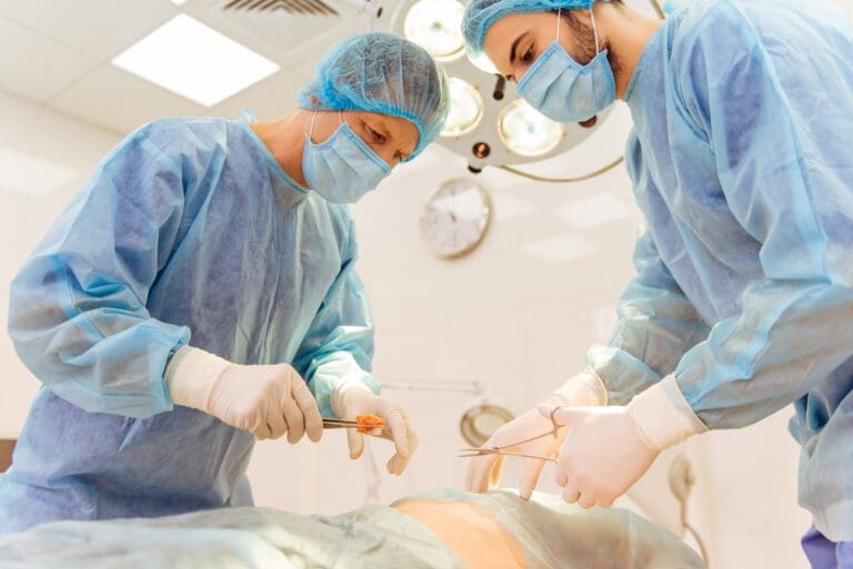 Team surgeons are performing an operation using medical instruments, in a modern operating room